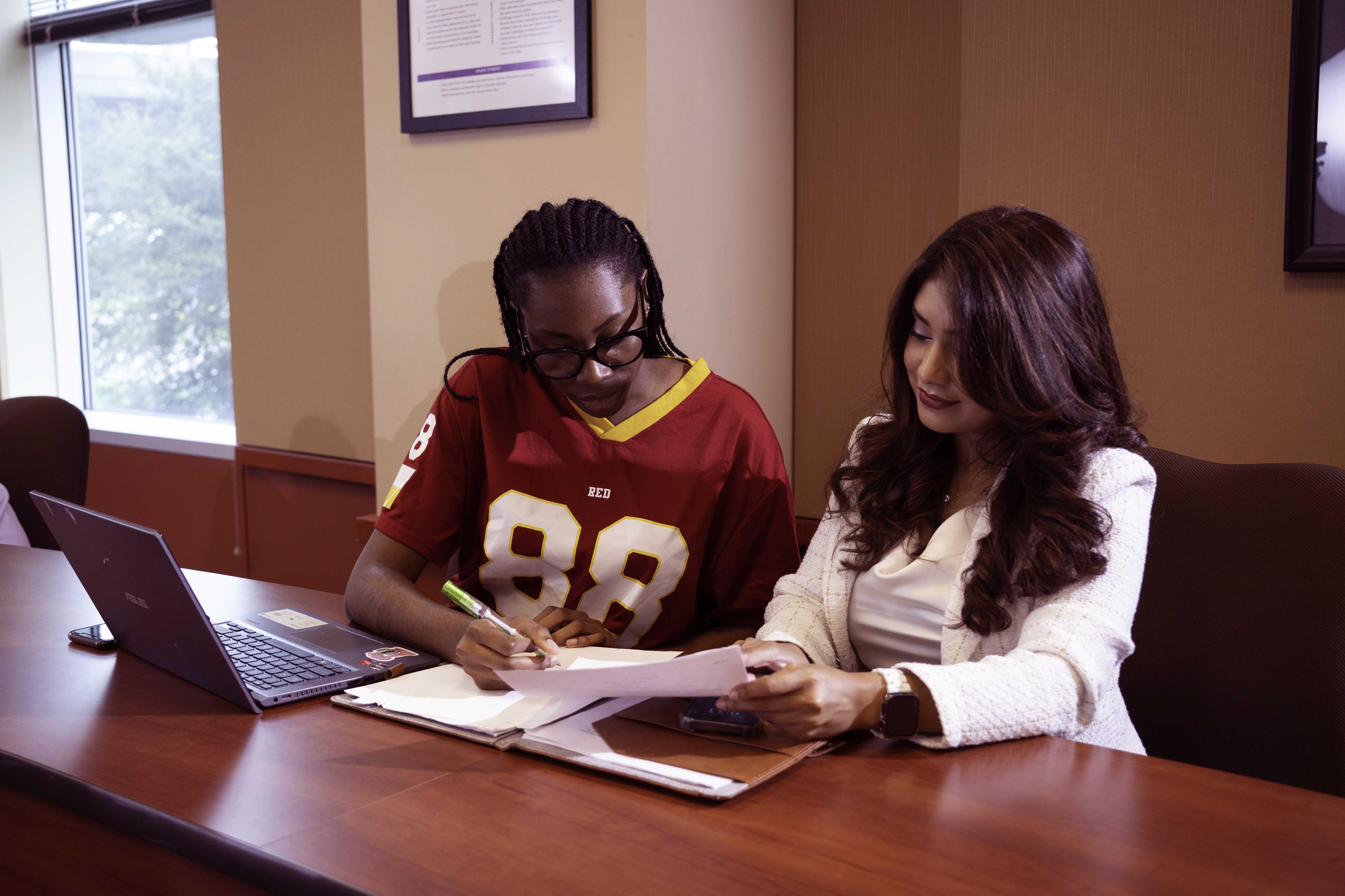 two students looking over their work