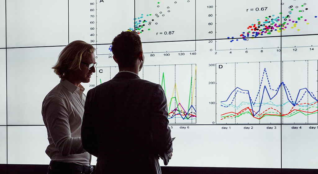 two people looking at a chart.