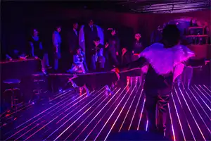 purple lights illuminate a bar