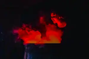 red illumiated smoke and an actor 