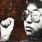 young boy wearing sunglasses holds up one fist 