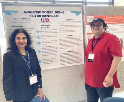 Student and Faculty standing infront of poster