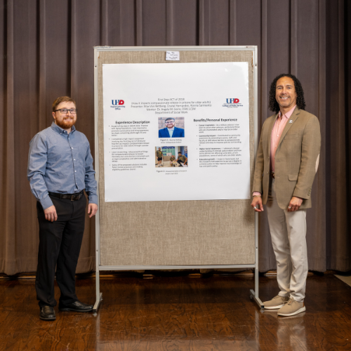 Student and Faculty standing infront of poster