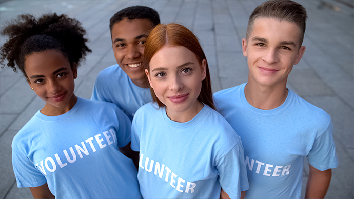 Group of teen volunteers smiling. 