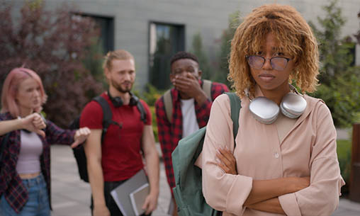 Student laughing at another student during hazing