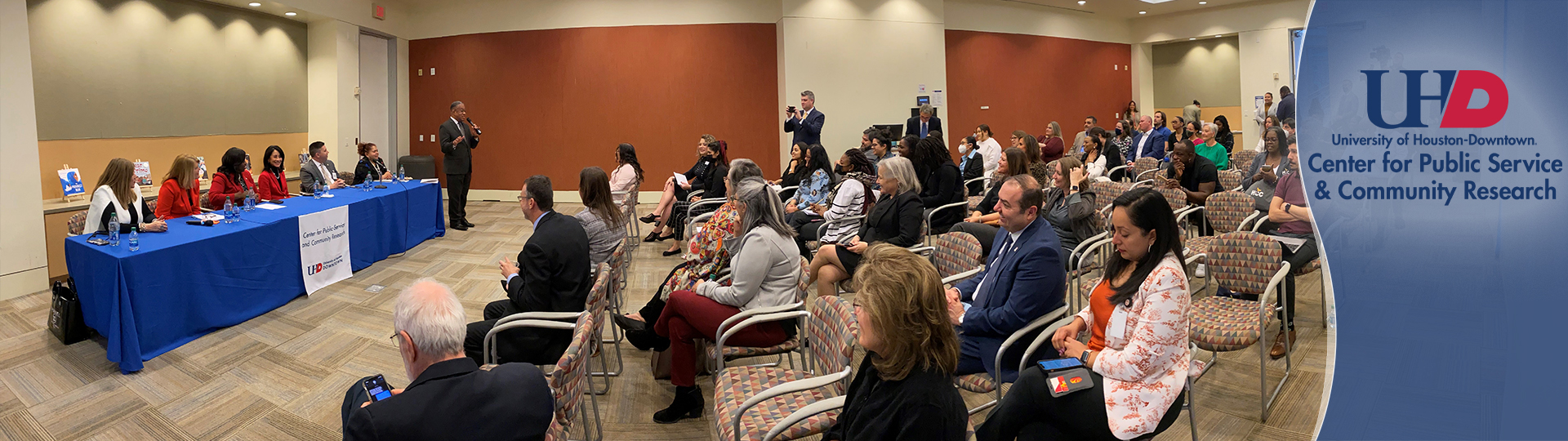 vitalvoices event in a lecture hall with a full audience an panel