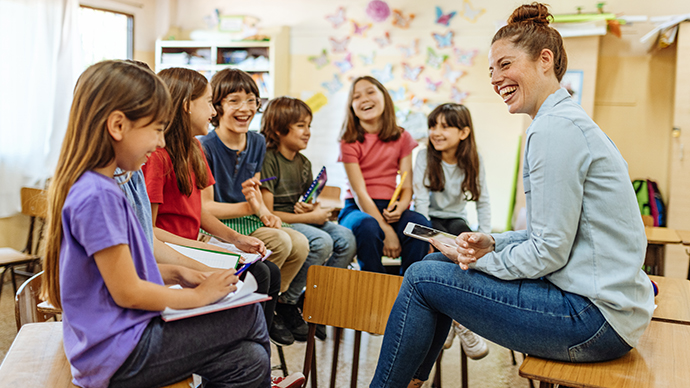 Teacher in a semi-circle with her students in class.