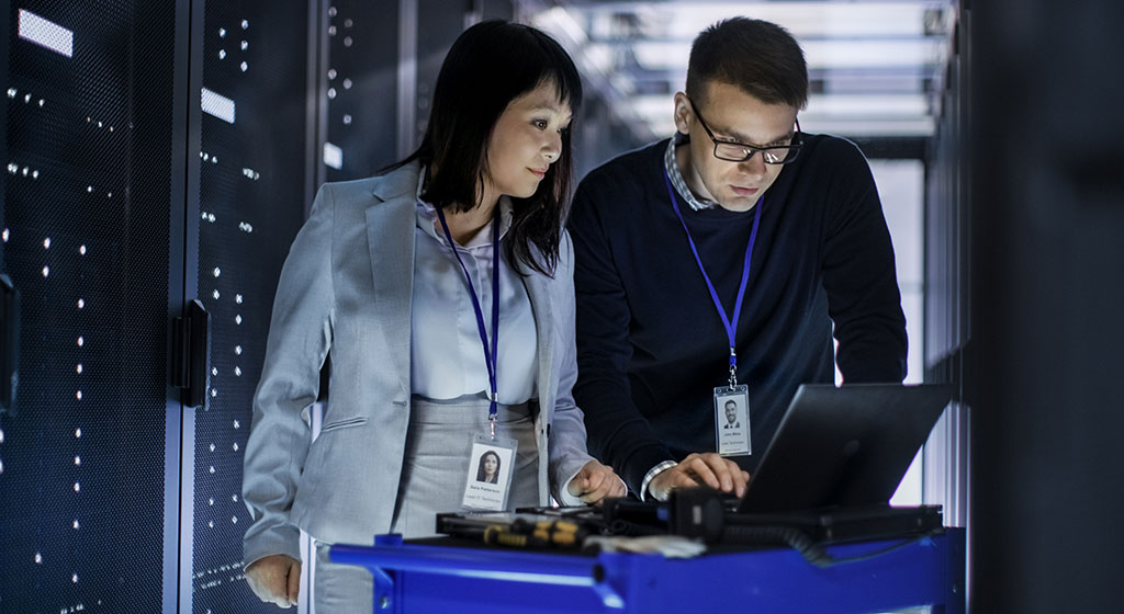 Two techs in a server room.