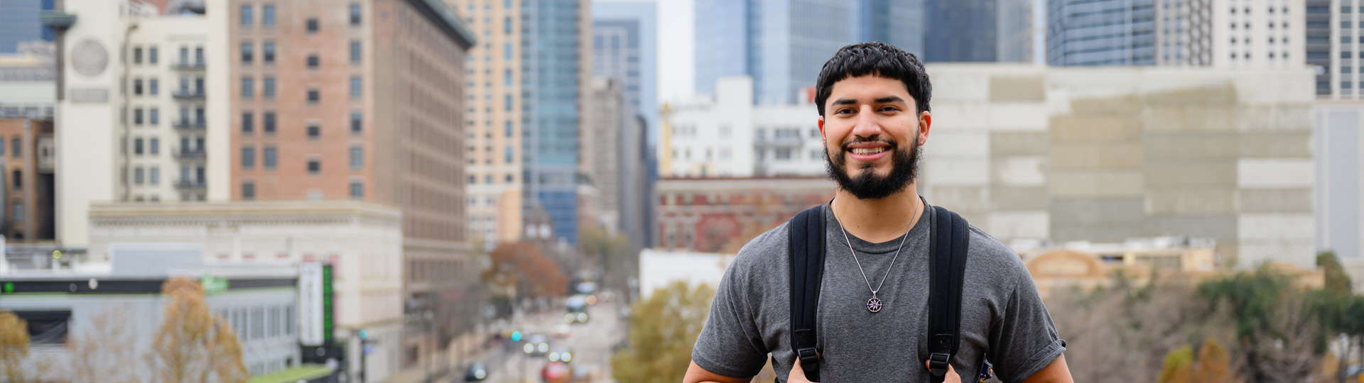 Smiling male student on the UHD portico