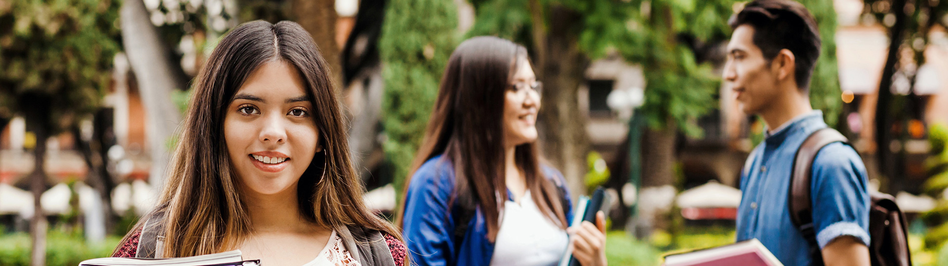 Latin female student and a group of Hispanic students in the background