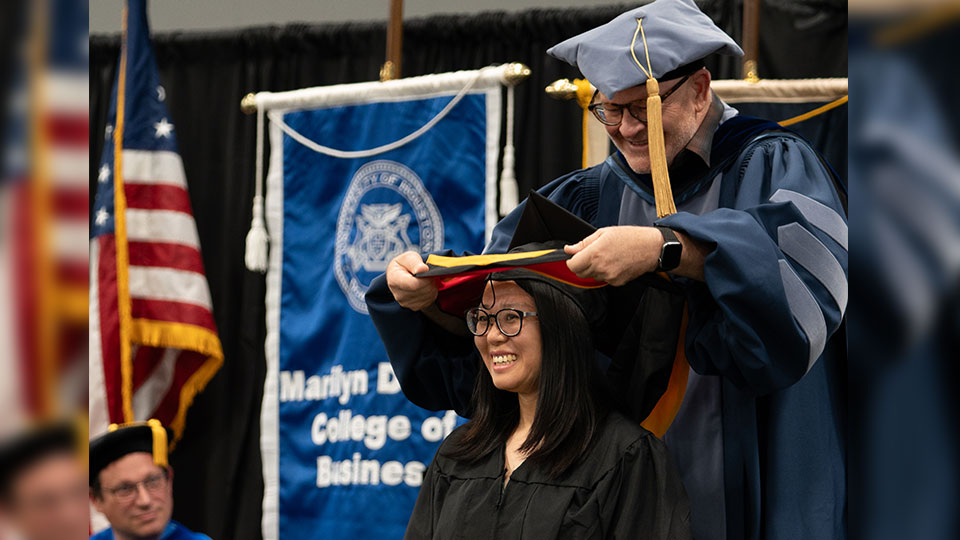 Woman receiving her masters hood