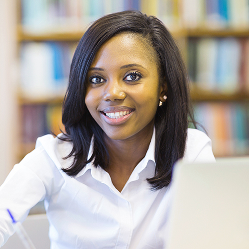 College student at a desk in a library