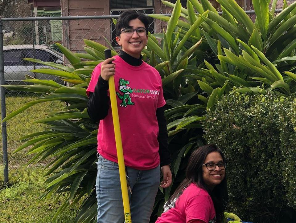 Two Students Posing near bushes