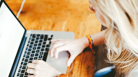 woman typing on laptop