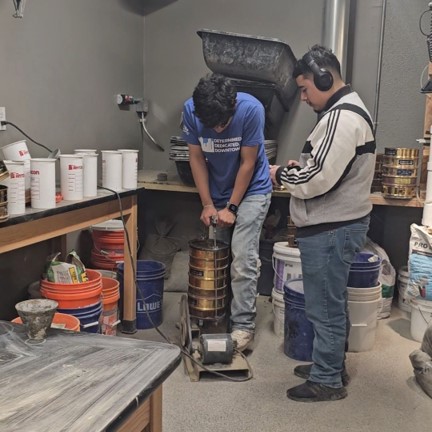 UHD students compete in the ACI Mortar Workability Competition. A student mixes a concrete mixture.