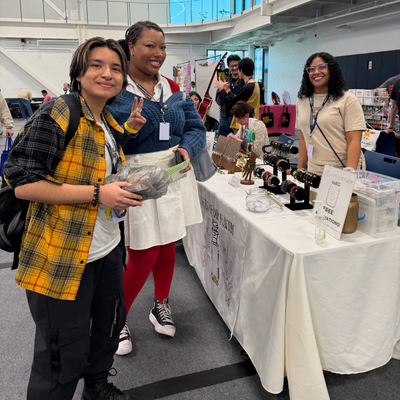 Two university of houston downtown students visit with a vendor at the wellness and success center on the campus of the university of houston downtown