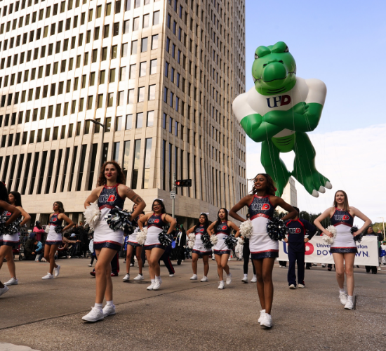 Cheerleaders at the university of houston downtown perform at the parade