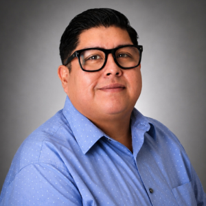 Esteban Smith smiles. Esteban is Web Support & Publications Coordinator for Academic Affairs at the University of Houston-Downtown 