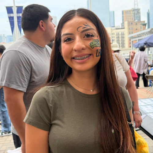 A high school senior and incoming University of Houston-Downtown student smiles with a facepainting of an alligator at the university of houston-downtown's commitment day in downtown houston 