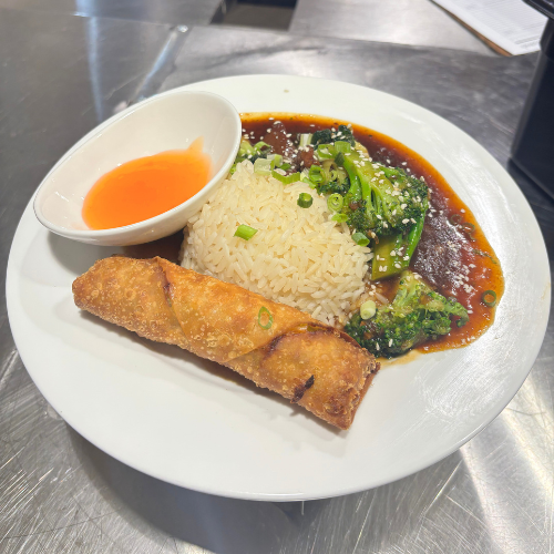 Beef stir fry, an egg roll, and rice on a plate at the university of houston-downtown food court. The plate is offered on Tuesdays. 