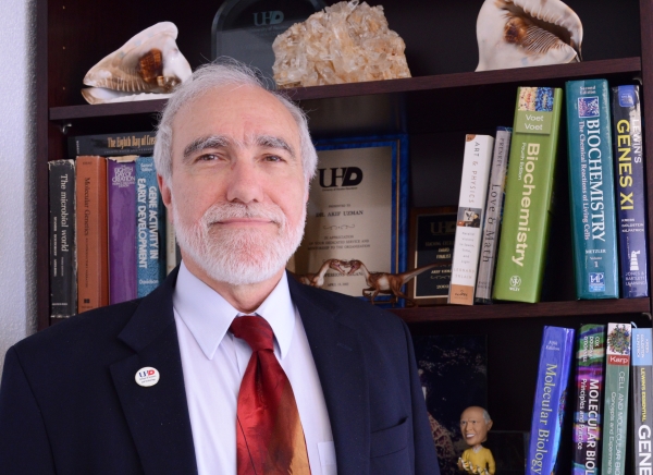 Dean Uzman in front of a bookcase