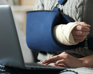 Someone with a broken arm is working on an application