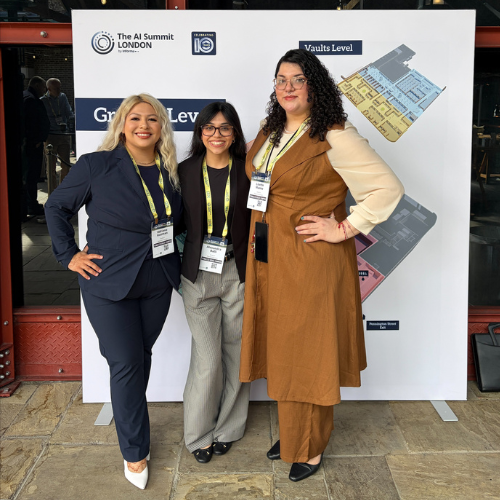 Adriana Guzman smiles with fellow Marilyn Davies College of Business students at the AI Summit London during a two-week study abroad course on artificial intelligence.