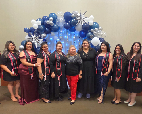 Urban Education majors and members of the University of Houston-Downtown's Bilingual Educators Student Organization smile while wearing cords and stole at a senior celebration at the University of Houston-Downtown in Houston, Texas