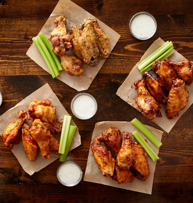 Chicken wings on paper towel with celery and ranch sauce