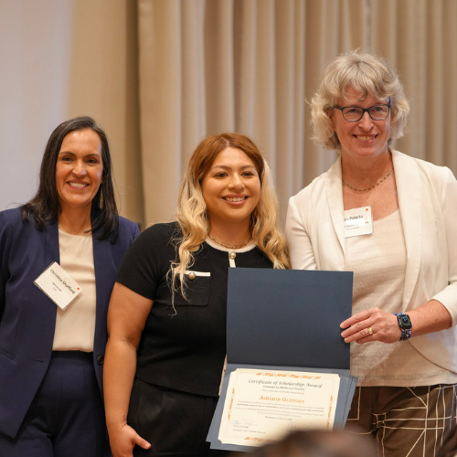 Adriana Guzman a University of Houston-Downtown student smiles aside two adults in the Society of Information Management Women at an awards ceremony. Guzman is the recipient of the 2026 SIM Women Scholarship. 